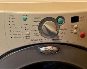 LIKE NEW WHIRLPOOL FRONT LOADER WASHER AND DRYER WITH PEDESTALS.