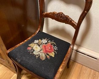 Antique chair with needlepoint seat.