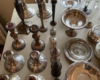 Large selection of sterling silver candlesticks, S & P shakers, bowls, and more.