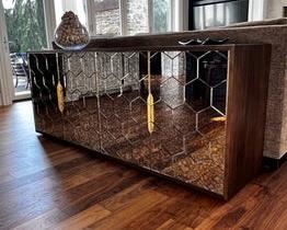 $4400 USD      Four Hands Cybil Mirrored Sideboard Buffet Dark Walnut CH165-10     Description:  Ornate detailing places a trend-forward spin on streamlined shaping. Dark walnut encases glass doors of antique mirror with a honeycomb pattern, adding artistic intrigue to statement storage. Stainless steel hardware is finished in polished brass for a look of effortless sophistication.  Constructed from walnut wood, glass and stainless steel. Finished in dark walnut, antique mirror and polished brass. Ornate detailing places a trend-forward spin on streamlined shaping. Glass doors of antique mirror with a honeycomb pattern, adding artistic intrigue to statement storage. Adjustable shelves
Dimensions: 31.5 inches high x 78.75 inches wide x 19.75 inches deep.  202 lbs
Condition: New out of box. 
Location: Local pick up Lake Oswego, OR. Shipper suggestions available upon request.      https://goodbyhello.com/products/copy-of-antique-19th-century-washstand-end-table-bedside-table-ch165-4?_