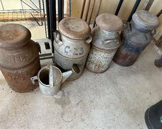 milk cans and a sprinkling can