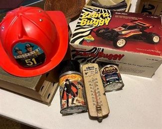 From the TV show EMERGENCY! Fireman's toy helmet, a Zorro Thermos, a Blackhawk Pontiac-Cadilac thermometer 100 Grant St., Fort Atkinson!!, a remote control Zebra Buggy - NIB, and an interesting Mushroom can from FRED's Fresh Grown!!