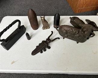 left side - iron, Rin Tin Tin door stop, boot jack, 30mm & 57mm anti tank projectile, WW2 75mm  Sherman tank projectile,                                                                                right side - Griswold Cast Iron, Easter Lamb Cake Mold/Form, #865 & 866, 2 pc set.