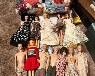 early Barbie and Ken dolls and lots of clothes.