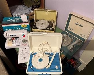 On the left - a White Mighty Mender w/ instructions and box.                                          Top is an RCA phonograph,                             Up front the Concert Hall phonograph,  On the right- the Starflite phonograph.