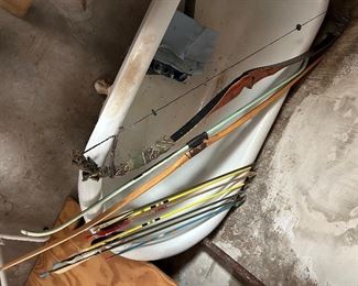 three hunting bows and a few arrows