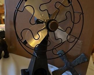On the left a Sterling engine fan (runs on denatured alcohol).                                       On the right.Katanga Copper Cross ingot (old Congolese money) 