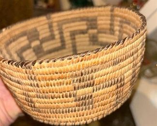 I believe this is a Tohono O’odham coiled weave basket. The Tpohono O’dham tribe is from Arizona and I believe this is quite an old piece. The flash of the camera illuminates and the darkness on the outside of the approximate 7 1/2 inch bowl.