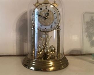 beautiful clock in a crystal cage with gold gonads