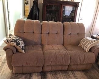 Sofa with some wear.   Reclines on each end. 
