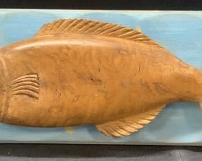 Polished Carved Wooden Fish On Painted Panel
