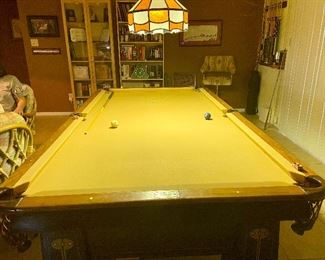 Table's Cushion Rails: Made up with what is known as a 3-ply body consisting of three layers of woods of alternating grain glued together to insure the rails against climatic changes. The center piece of these plies is hard maple, the most suitable wood to hold the cushion bolts firmly. The top of the rail is covered with a rail cap of compound construction faced with solid rosewood. The rails are securely fastened to the table by invisible cushion bolts. These bolts are covered by blind cushion rail facing which is built up of 5-ply compound construction and faced with a selected grade of figured Mahogany veneer. Table's Cushions: Monarch perfect angle cushion.
