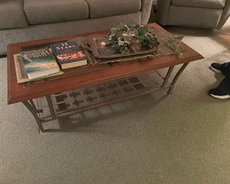 . . . nice glass-topped coffee table with wrought-iron base and glass in lay