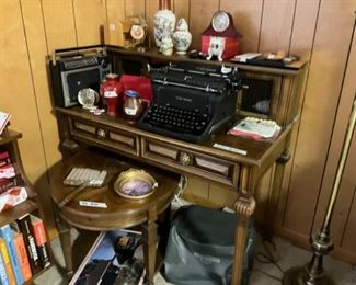 Vintage desk, round side table, books, decor, radio, and vintage Underwood manual typewriter