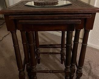 Leather nesting tables together or can be taken out and used separately. Measurements are largest table is 19 1/2 x 17 1/2.