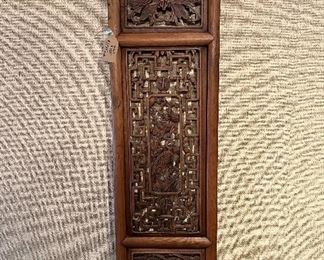 Closeup of one antique Asian wooden art panel.