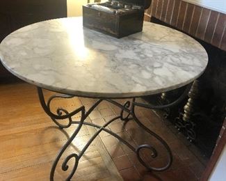 Marble top table on wrought iron base