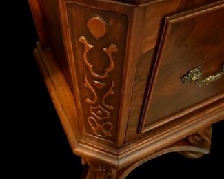 Antique night table with clock/intricate wood carving.
