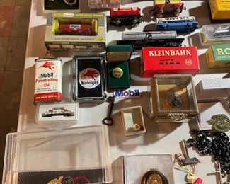 Tin trains and trucks, assortment of jewelry. 