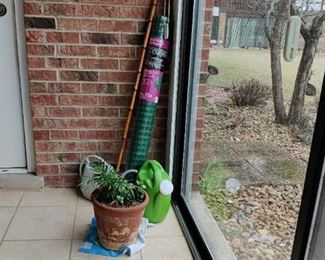 planter wit, wood walking stick plant, watering can, plastic fencing