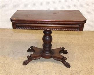 
Lot 614
Antique empire mahogany paw foot flip top game table
