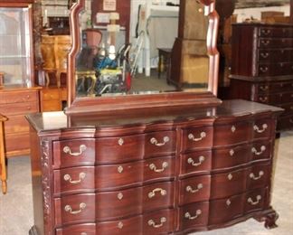 
Lot 638
Quality Production Hall Limited solid carved mahogany 8 drawer low chest with mirror
