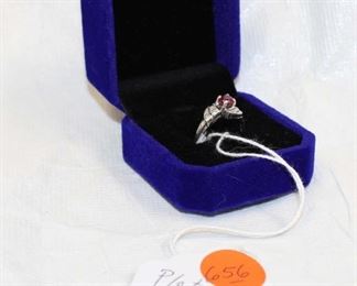 
Lot 656
Platinum band with diamonds and ruby style stone ring size 5.5
