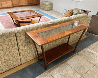 Console table - wood and glass there is a coffee table and a side table as well as a large sectional and carpet 