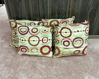 Four mod-style plush throw pillows