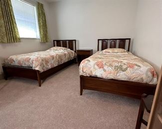 Pair of vintage Broyhill Emphasis walnut twin bed frames with side rails and coordinating side table