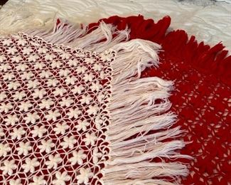 Crocheted shawls in red and one in white