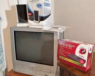 Magnavox box tv with DVD & VHS Player, RCA antenna, and digital-to-analog converter box with tv stand