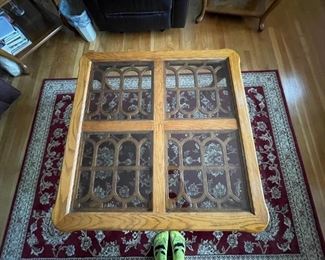 Top of the larger wooden coffee table. Four separate panels of glass for the top.