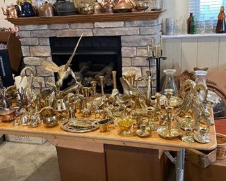 Large assortment of brass collectibles ranging from duck book ends, several sets of candle sticks.