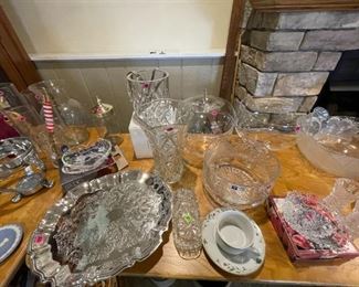 Crystal dining ware items ranging from bowls, platters, butter dish, vases, etc.