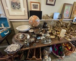 A vast collection of silver cutlery, platters, bowls, vases; and a variety of brass animals, candle holders, etc.