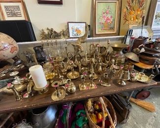 A vast collection of refurbished/repolished brass animals, candle holders, spittoon, and more.