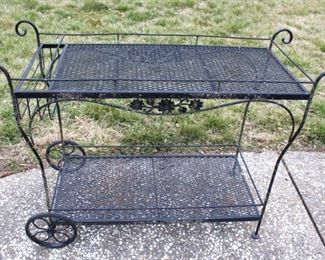 Black garden cart with wheels.