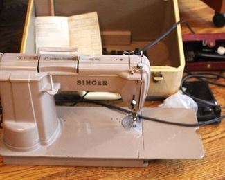 Singer sewing machine model 301 with attachments.
