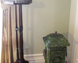 Pedestal, porcelain pitcher and green enameled stove.