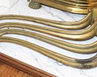 Four curved brass table legs.