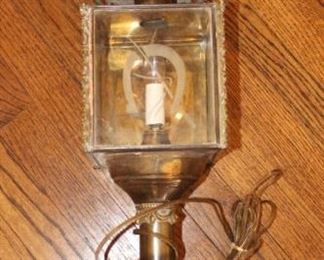 Carriage light with etched horseshoe on glass panels.