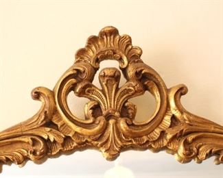 Detail of top of gilded mirror.