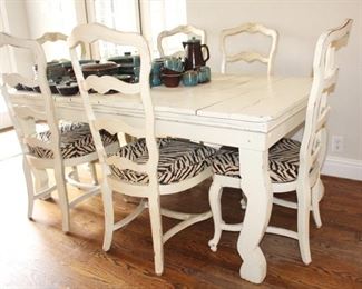 Primitive painted farm table, shown with six painted and upholstered chairs sold separately.
