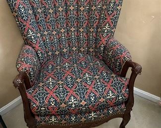 Upholstered tufted wingback chair.