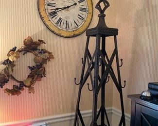 Wrought iron coat rack and Paris style wall clock.