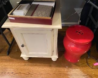 Small chest and red plant stand.