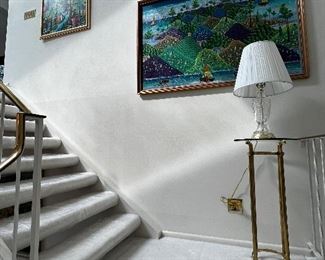 Stair landing with glass top brass lamp stand