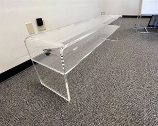 $725  Clear Home Acrylic Waterfall Rectangular Bench w Storage Shelf MTF153-3                   
Description:  Clear Waterfall Rectangular Bench with Storage Shelf is made with 3/4" thick acrylic and "waterfall" rounded corners, making it soft yet modern. This is a minimal, contemporary Lucite bench with a thick storage shelf built in. In furniture quality clear acrylic, this retro style bench is perfect for chic mudrooms, hallways and foyers. Clear 3/4" thick acrylic.  Fixed shelf
Dimensions: 54"w x 24"d x 18"h
Condition: New with only 2 pinpoint marks due to shipping  See photo's for more detail.
Location: Local pick up Portland, OR.  Shipper suggestions available upon request.  Item is in a warehouse with easy bay door access.