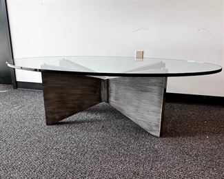 $1000 Kravet Oval Glass Top Oval Coffee Table  MTF153-13  DESCRIPTION:  Kravet's large oval cocktail/coffee table with substantial cross base in a grey painted wood with 3/4 inch oval glass top. This clean, simple look with sculptural angles beautifully complements other decor while standing out as functional art. Well made table constructed with extraordinary care. Kravet is a century old, family-owned home furnishings business known for its superb craftsmanship and attention to detail.

Dimensions: 60 x 32 x 18.5 H in.  |  3/4 in thick glass top

Condition: New.  The piece was an interior design custom order. The glass top has an internal chip incurred during shipping.  The outside suffers no cracking or chipping and is as smooth to the touch as new glass.  Glass top is easily replaceable.

Location: Local pick up Portland, OR.  Shipping suggestions available upon request. 